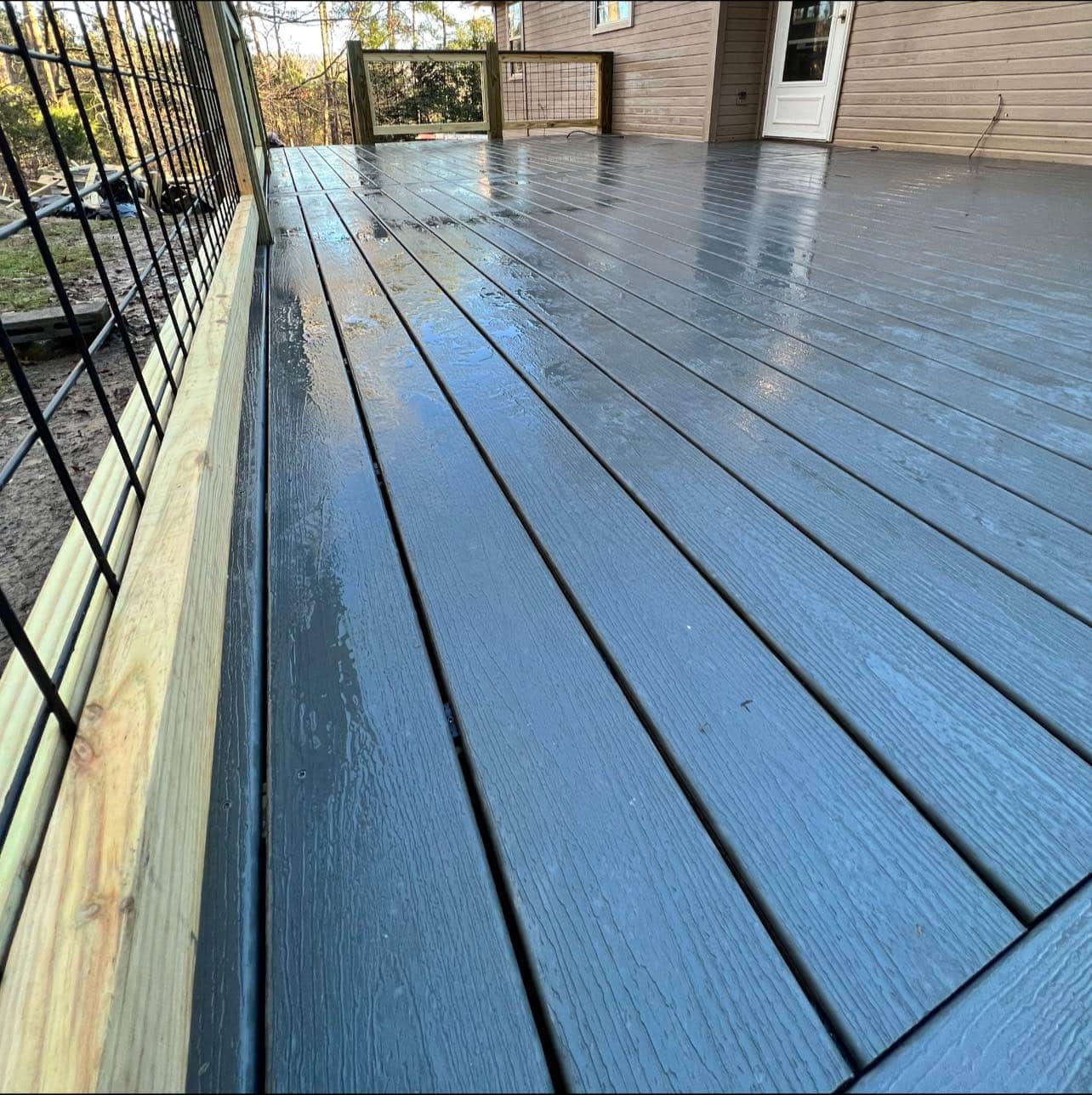 Ground-level composite deck with wide steps built by Arellano Construction